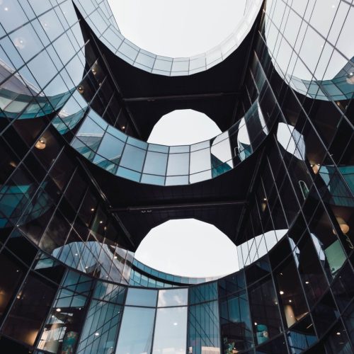 low-angle-shot-of-modern-design-of-an-architectural-building-with-reflections-on-a-glass-window.jpg